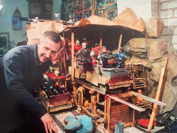 Richard Dixon with one if the sets he has built to complement his photography and, inset, with one of the models he created for Infinite Worlds movie