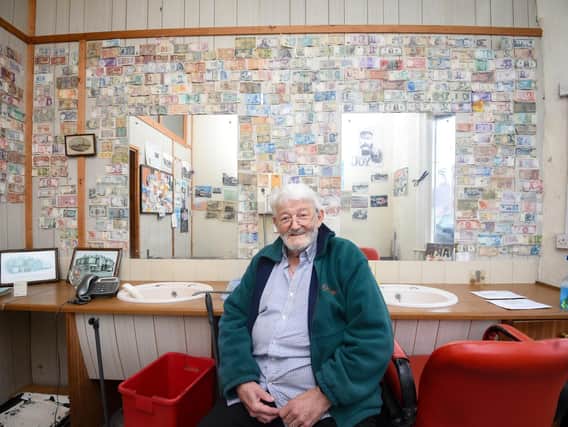 Barber Stuart Taylor is retiring after 30 years and plans to auction the collection of foreign money on his wall for charity.