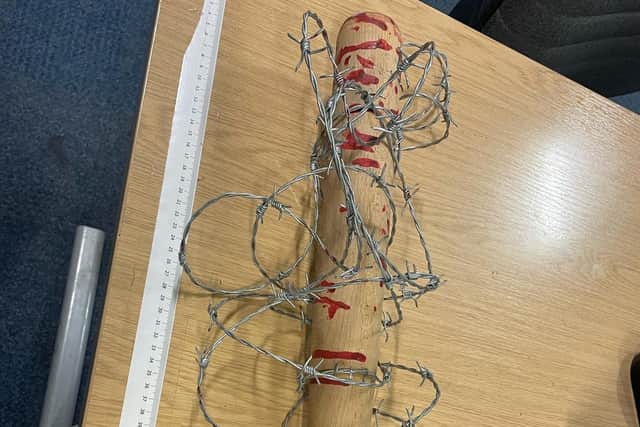 A man has been arrested after a 'blood-spattered' baseball bat wrapped in barbed wire - familiar to Walking Dead fans as villain Negan's spiky pal 'Lucille' - was seized by police in Fleetwood