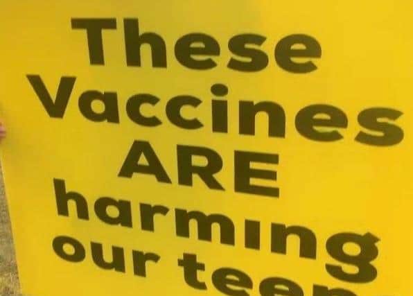 One of the signs - bearing a fake claim about the Covid jab - held aloft outside Lytham St Annes High School earlier this week