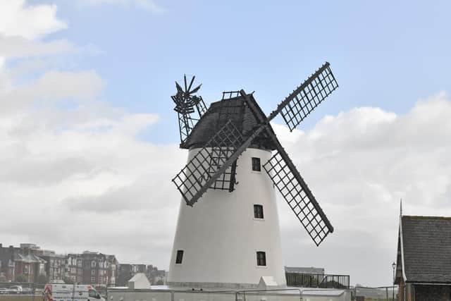 Lytham Windmill with its broken sail, cordoned off with fencing