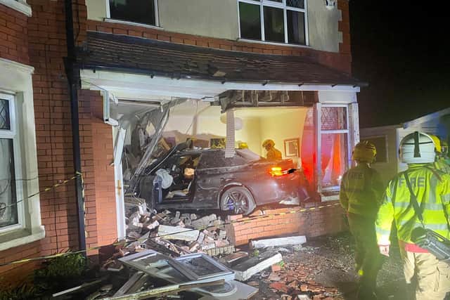 The BMW crashed into the house at around 1am on Monday