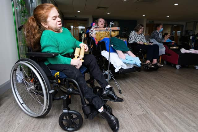 A Sue Ryder client keeps time, enjoying the rhythm of the music