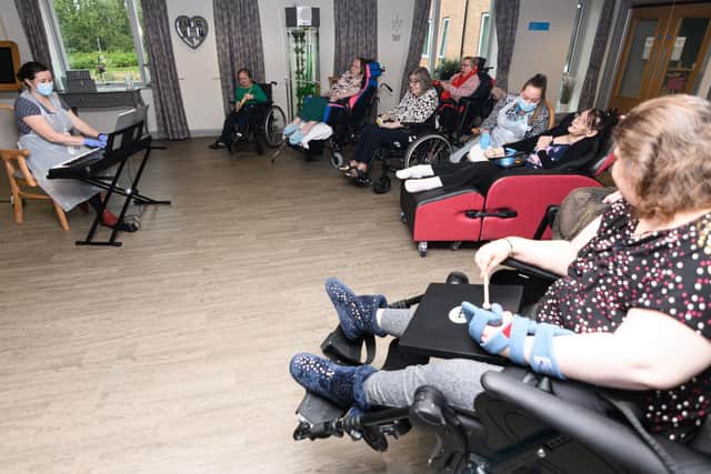 Music therapist Clare Maddocks leads a group music therapy session at the Fulwood centre