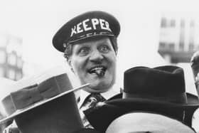 Tommy Cooper tries out some hats. Photo: Getty Images