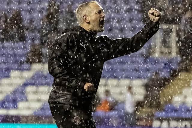 Neil Critchley celebrates with the Pool fans at full-time