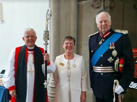 Enid Nutland with the Bishop of Blackburn, The Right Reverend Julian Henderson (left) and the Lord Lieutenant of Lancashire, Lord Shuttleworth