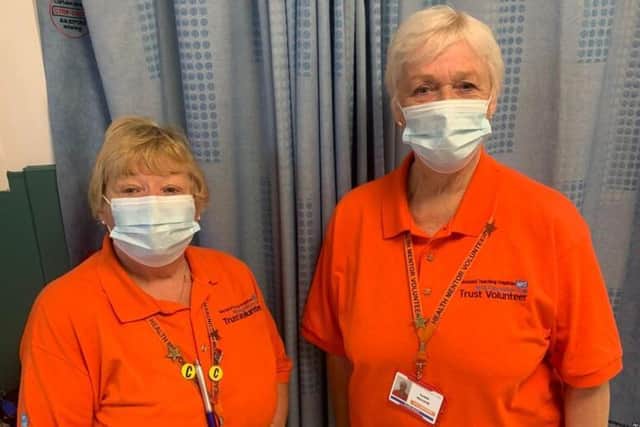 The helpers, who wear tangerine shirts, perform a range of duties including preparing food and refreshments for staff and patients, as well as providing support to patients and being a friendly face to speak to