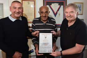 Billy Boston receives his Blackpool Borough heritage number 
certificate from Keith Sutch (left) of the club’s Heritage Group and former player Graham Mayor (right)