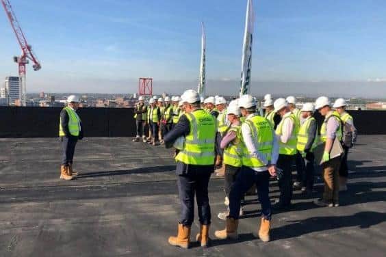 Staff from Create Construction topping out a the Hampton By Hilton hotel they built in Manchester in 2019