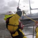 Crew Al Sleet throws a heaving line to colleague Andy Hall on the yacht (Credit: Lytham St Annes RNLI / Ben McGarry)