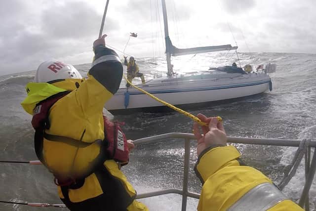 Crew Al Sleet throws a heaving line to colleague Andy Hall on the yacht (Credit: Lytham St Annes RNLI / Ben McGarry)