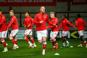 Fleetwood defender Tom Clarke warms up ahead of the Wigan game
