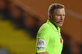 Referee John Busby was spotted picking up some of the objects thrown onto the pitch