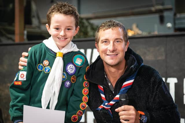 Oliver is presented with his Scout's award by Bear Grylls