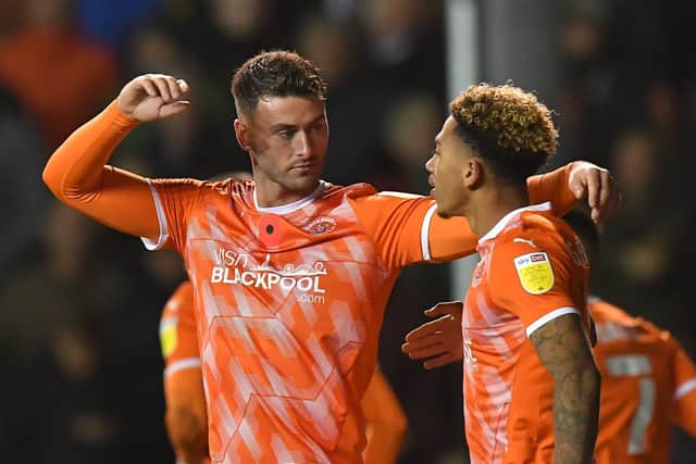 Gary Madine celebrates Blackpool's equaliser with Jordan Gabriel in the terrific televised encounter with QPR