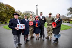 Lytham St Annes poppy appeal organiser Coun Ed Nash, Andy Broadbent, Cpl David McKenna, volunteer Gillian Guest, Brad Cowan, Csgt Rich Joynes and Edyta Paxton from Fylde Counci at the War Memorial in Ashton Gardens, St Annes