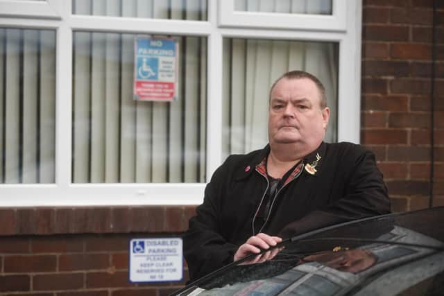 Mike Bowyer, with signs outside his house on Custom House Lane in Fleetwood