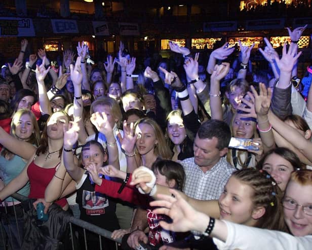 Fans wait for a glimpse of Busted when they performed an invitation only gig at the Tower, November 2003