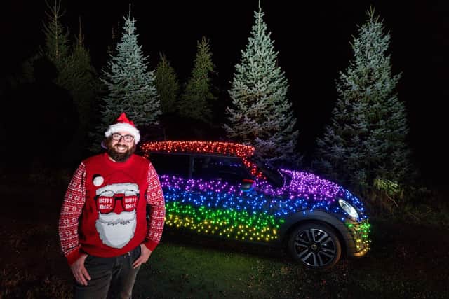 Nico Martin with the Mini Electric wrapped in thousands of Christmas fairy lights (Picture: Jacob King/PA Images)