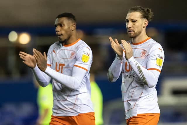 A disappointed James Husband and Dujon Sterling applaud the Blackpool fans at the final whistle