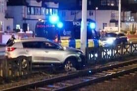 The silver car smashed through the concrete fencing separating the road and tramway (Photo by Liam Otley)