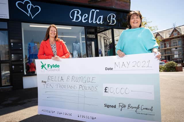 The first ARG cheque announced in May - Fylde Council leader Karen Buckley hands £10,000 in grant money to Aisha Rayson of the Bella B boutique in St Annes