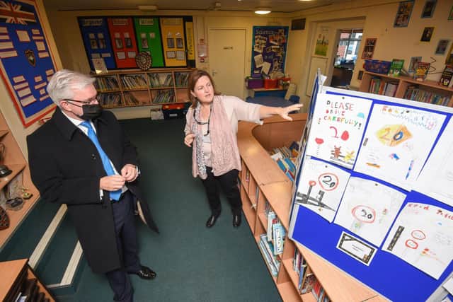The school's chairman of governors, Gill Metherell, shows Mr Menzies some of the pupils' road safety posters
