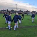 The teams warm up at Norton