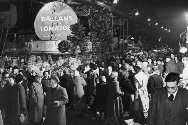 A sign reading 'Ballan's for Tomatoes' entices shoppers.