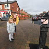 Henrietta Duncombe, four, admires the figures outside Ansdell Post Office with mum and Charlotte