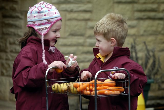 Declan Mitchel gets fruit from Mia Stott as they show Brabins Endowed Primary School's commitment to being a sustainable school