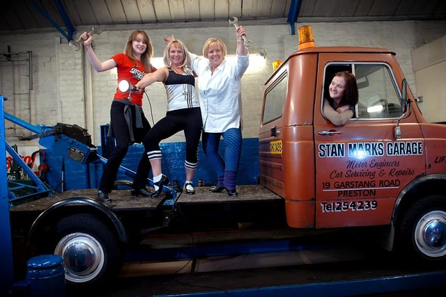 Some of the cast members from Broughton Club Players rehearse “Stepping Out” in unusual circumstances at Stan Marks Garage on Garstang Road in Preston, from left, Bridget Buckley, Lynn Carroll and Trilby Beetham, with driver Lorna Cookson keeping an eye on the tap routines