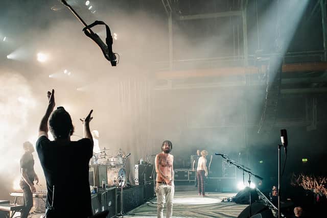 Guitar technician Richard Pratt from Preston catches a guitar thrown by Biffy Clyro singer Simon Neil. Pic by Carla Mundy
