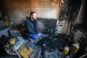 Chris Gregory at his fire damaged lounge at Mill Close in Thornton