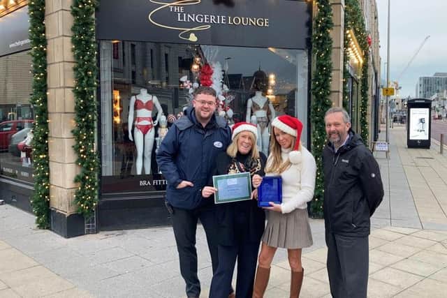 The Lingerie Lounge team is presented with its certificate for having the best festive windows in Blackpool