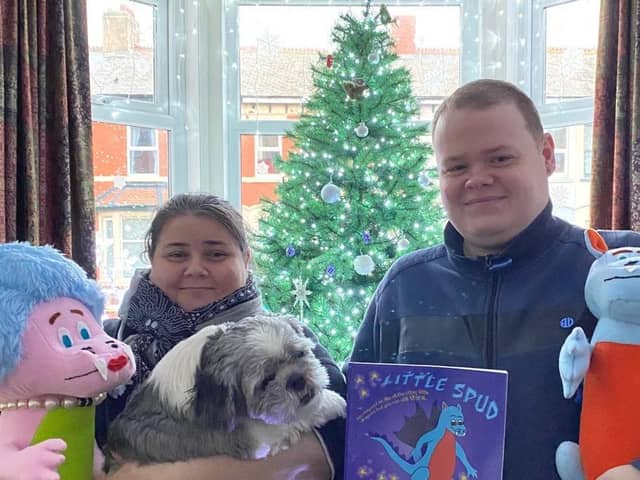 Author Marie Stell, Winston the Shih Tzu, and Christopher with the Little Spud the dragon book and characters made by Janet Earl