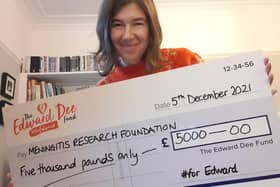 Elizabeth Dee with one of the cheque presented on the fifth anniversary of Edward's death