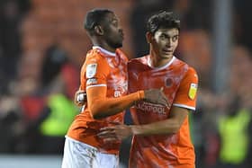 Dujon Sterling and Kenny Dougall embrace at the full-time whistle