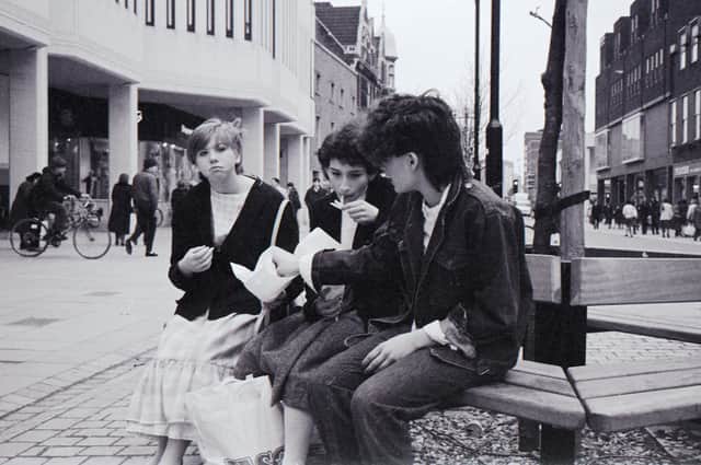 Friends Amanda Matthews (nee Gilbert), Silvia Diana and Sally Cross (nee Needham) were pictured tucking into chips on a bench in Long Causeway 1984 by Chris Porsz.