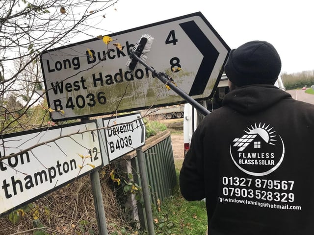 Brushing up the Long Buckby sign.