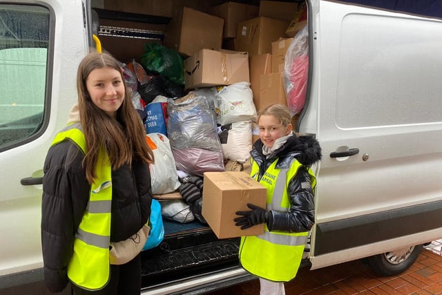 Freya Lyons, 14, and Belle Nicholls, 10, filliing a van with donations at the appeal at the Seafood Cafe in Skegness.