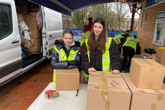 Belle Nicholls, 10, and Freya Lyons, 14, with volunteers at the appeal at the Seafood Cafe in Skegness.