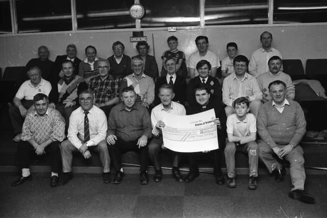 Mr. Willie Meehan, chairman of the Long Tower Old Boys’ Committee, presents a cheque of £1,000, the proceeds of a cabaret dance evening in the Delacroix lounge, to Rev. Eamon Graham, Derry Diocese representative of Trócaire. The cheque was presented at the committee’s weekly snooker session.