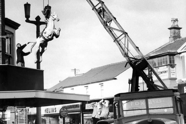 Fox Brothers of Blackpool lift a horse statue into place at Hunter's Meanswear on the corner of Clifton Street and Abingdon Street in 1964. It was in place for five years.