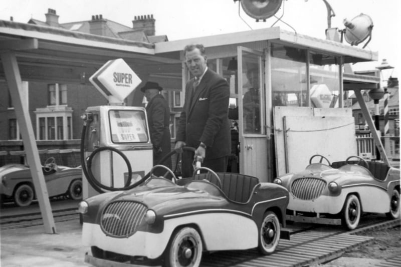 Albert Mason senior, 'tops up' the mini cars - no problem with petrol prices then