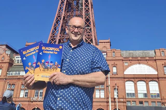 Tony Michael with copies of  the Blackpool Colouring Fun colouring book
