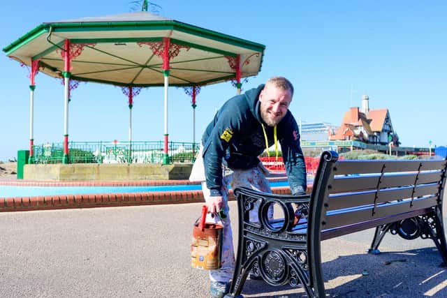 Contractor Anthony Twigg paints a bench on St Annes Promenade