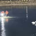 LFRS Lancashire firefighters rescued a trapped swan from a frozen lake