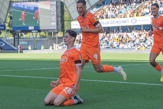 Charlie Patino slides on his knees in celebration after scoring Blackpool's equaliser